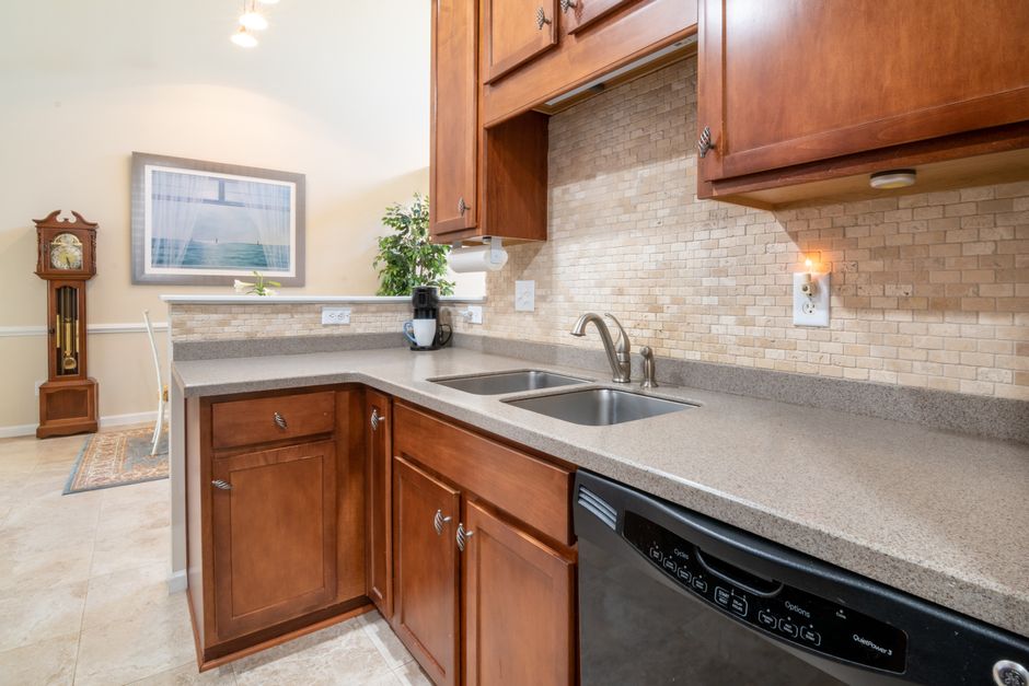 Elegant kitchen interior showcasing granite countertops and wooden cabinets.